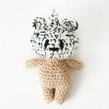 Crochet bag charm with a black and white patterned hat on a white background